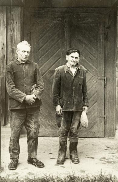Two Older Men in Front of the Entry Elements