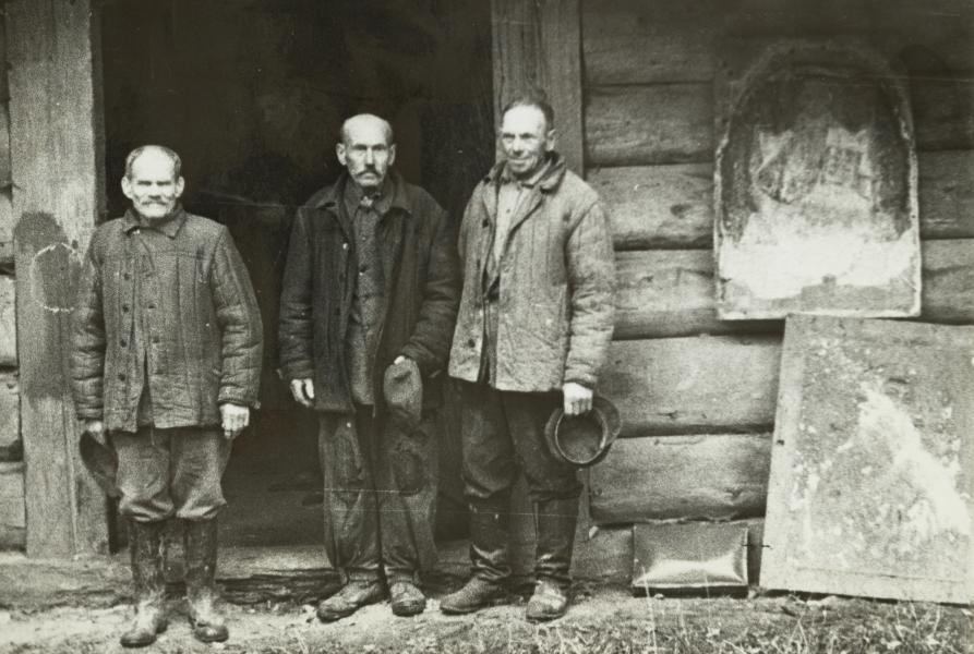 Older Men in Front of a Wooden Building